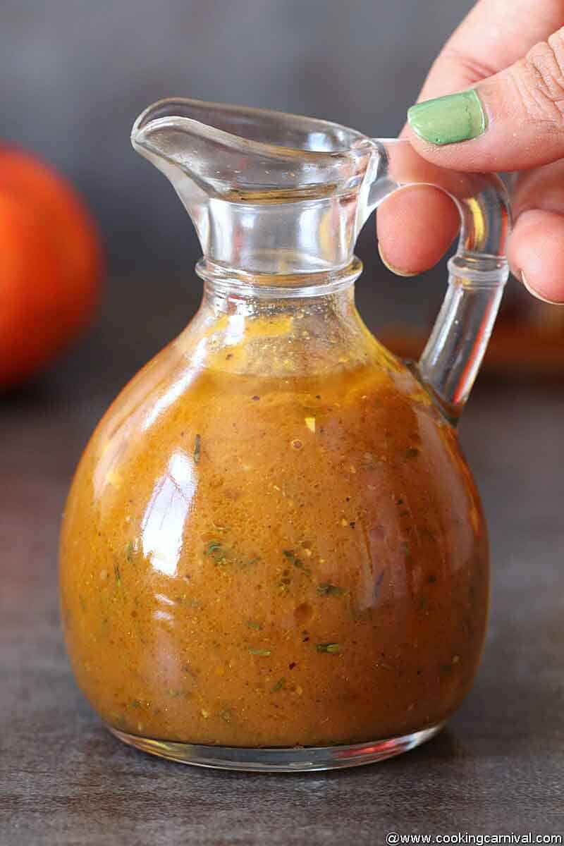 Holding bottle of Pumpkin-Vinaigrette