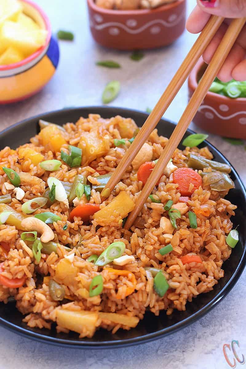 Classic and Exotic with tropical flavors - Thai Pineapple Fried Rice Recipe - Lovely blend of sweet- savory flavors and its Truly Heavenly. This Vegan Pineapple Fried rice preparation is a little bit spicy, tangy and sweet. Make it as the main course or as a side dish to any meal over the weekend. Thai Pineapple Fried rice is always a favorite.
